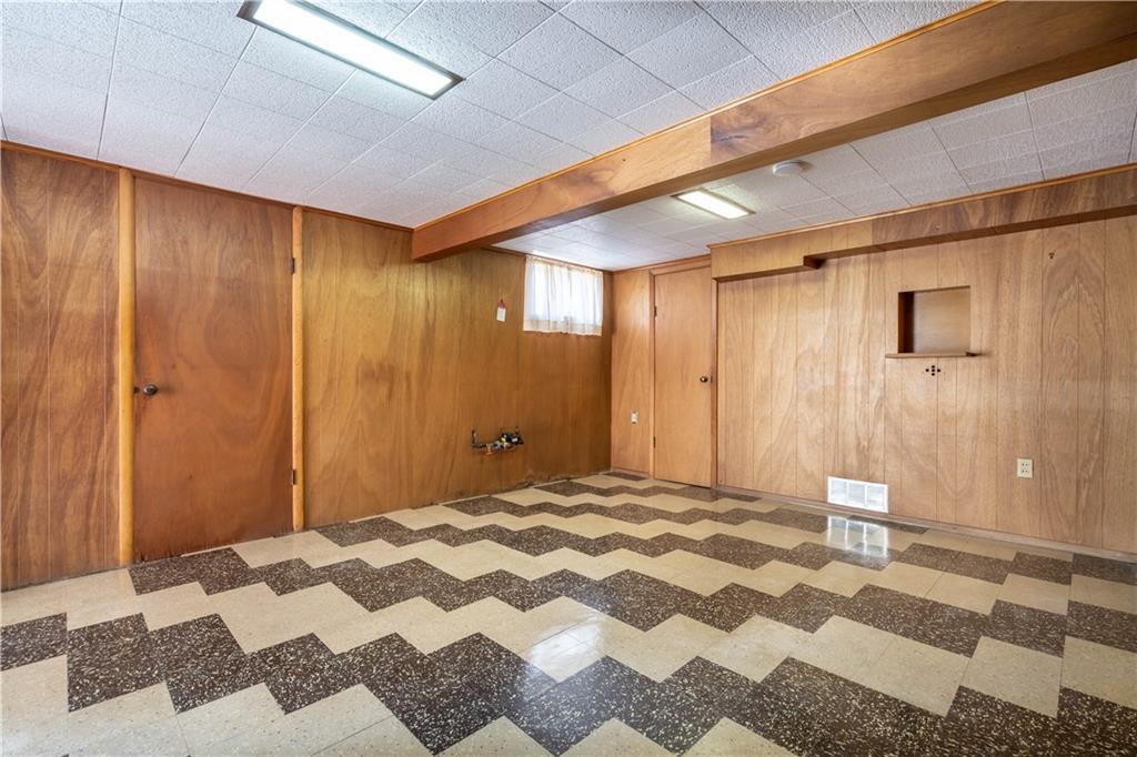 1465 Prospect Road Pittsburgh, PA 15227 - Photo 17 of 25 ANOTHER VIEW OF THE GAMEROOM SHOWING DOORS TO GARAGE AND LARGE WORKSHOP