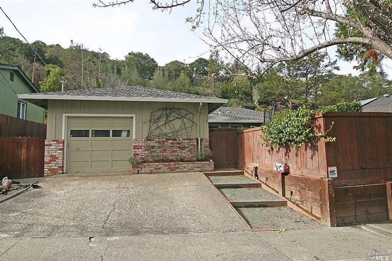 235 Irwin Street San Rafael, CA 94901 - Photo 1 of 1 a front view of a house with a garden and trees