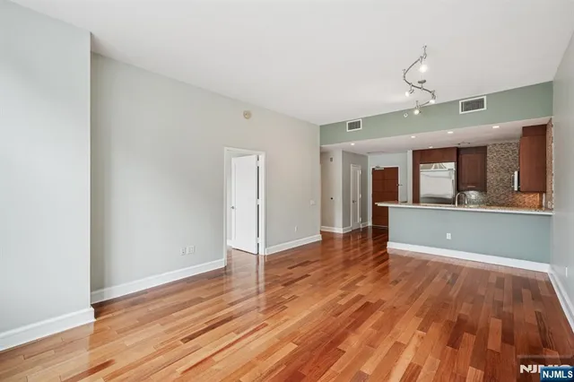 a kitchen with a sink and a wooden floor