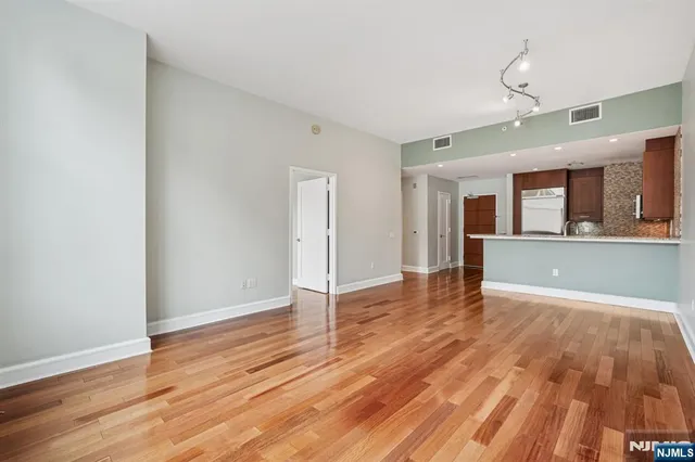a kitchen with stainless steel appliances granite countertop a refrigerator sink and stove