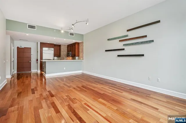 a kitchen with stainless steel appliances granite countertop a sink a stove and a microwave