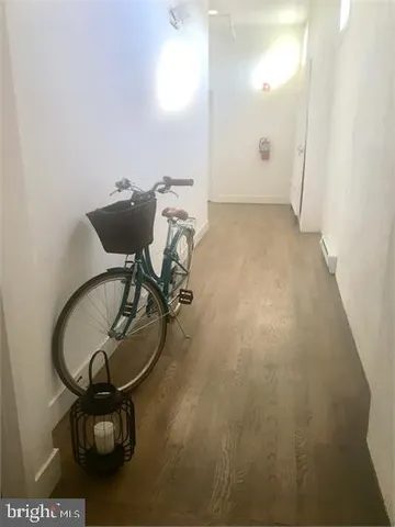 a picture of a room with wooden floor and windows