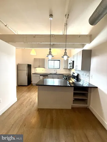 a view of a living room with furniture and floor to ceiling window