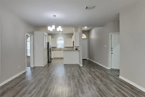 wooden floor in an empty room with a mirror