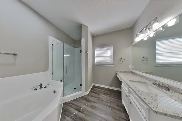 a bathroom with a bathtub and a sink
