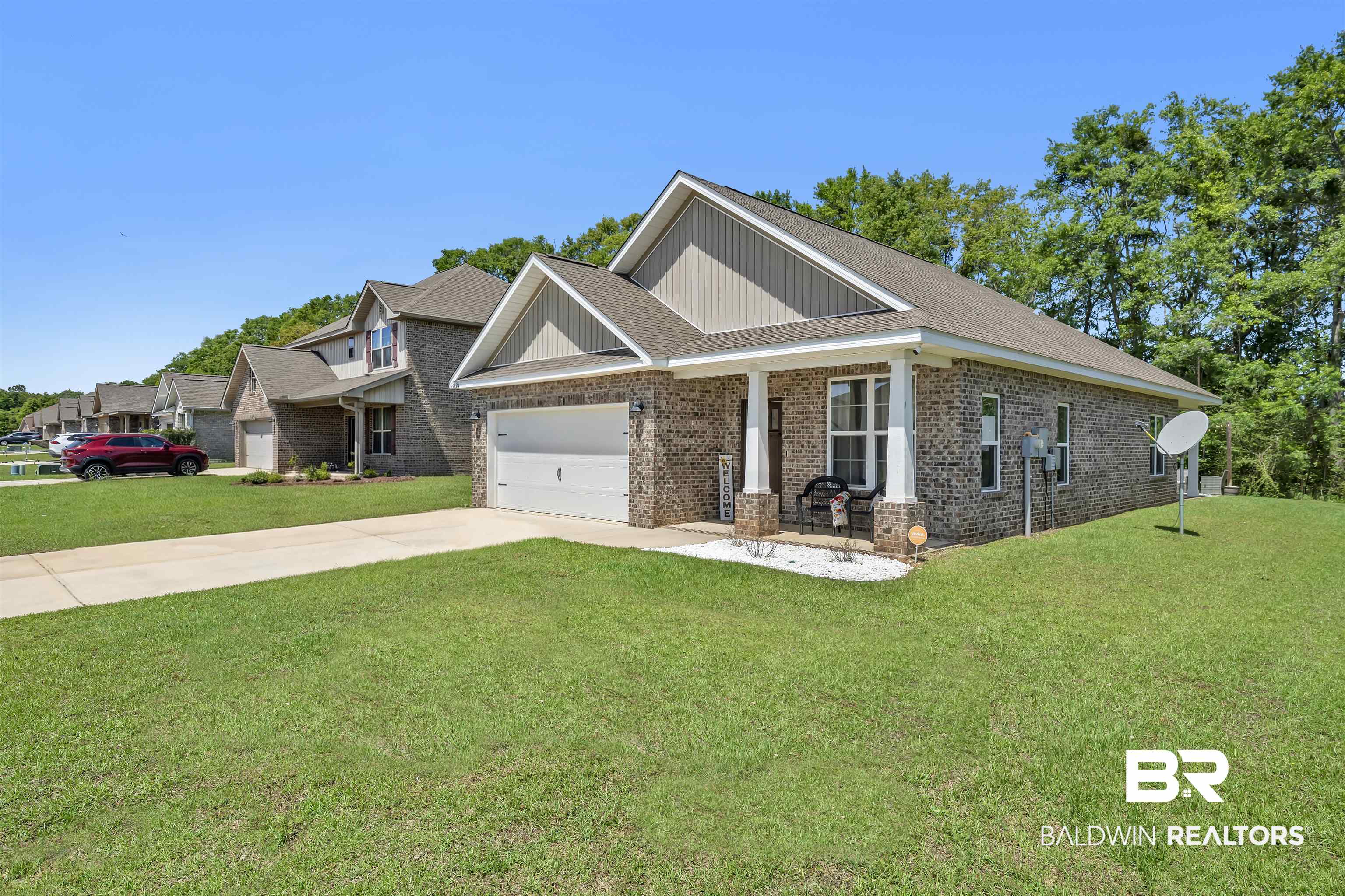 16504 Prado Loop Loxley, AL 36551 - Photo 3 of 45 Craftsman inspired home with brick siding, concrete driveway, covered porch, a front yard, and an attached garage