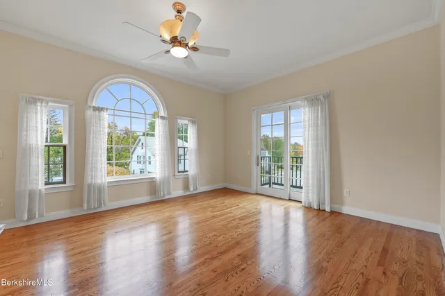 a view of a livingroom with furniture chandelier wooden floor and a chandelier