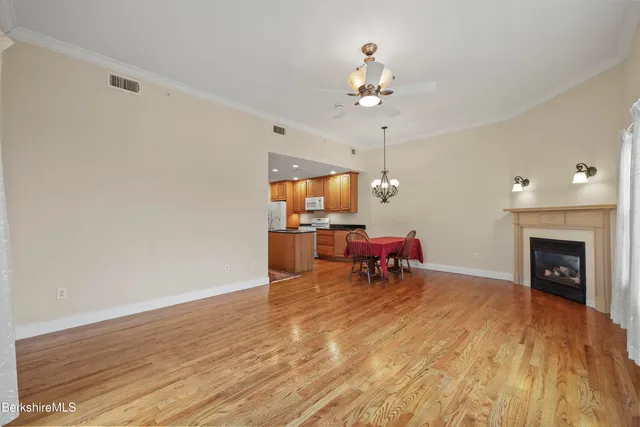 a view of wooden floor and windows in a room