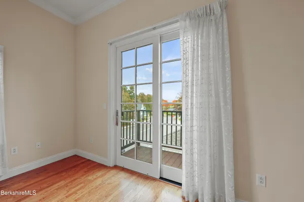 a view of a room with wooden floor and a sink