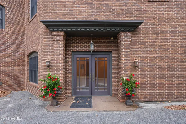 a front view of a house with outdoor seating