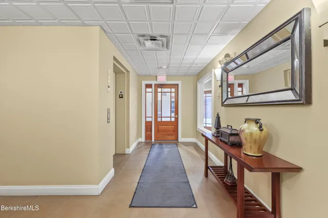 a hallway with a table and chairs