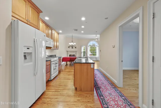 a kitchen with cabinets and wooden floor