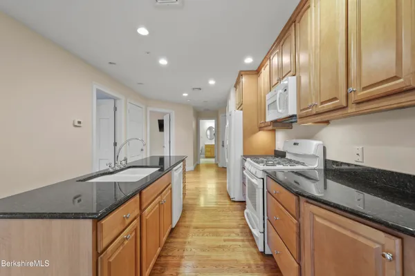 a bathroom with a toilet a sink a mirror a bathtub and shower