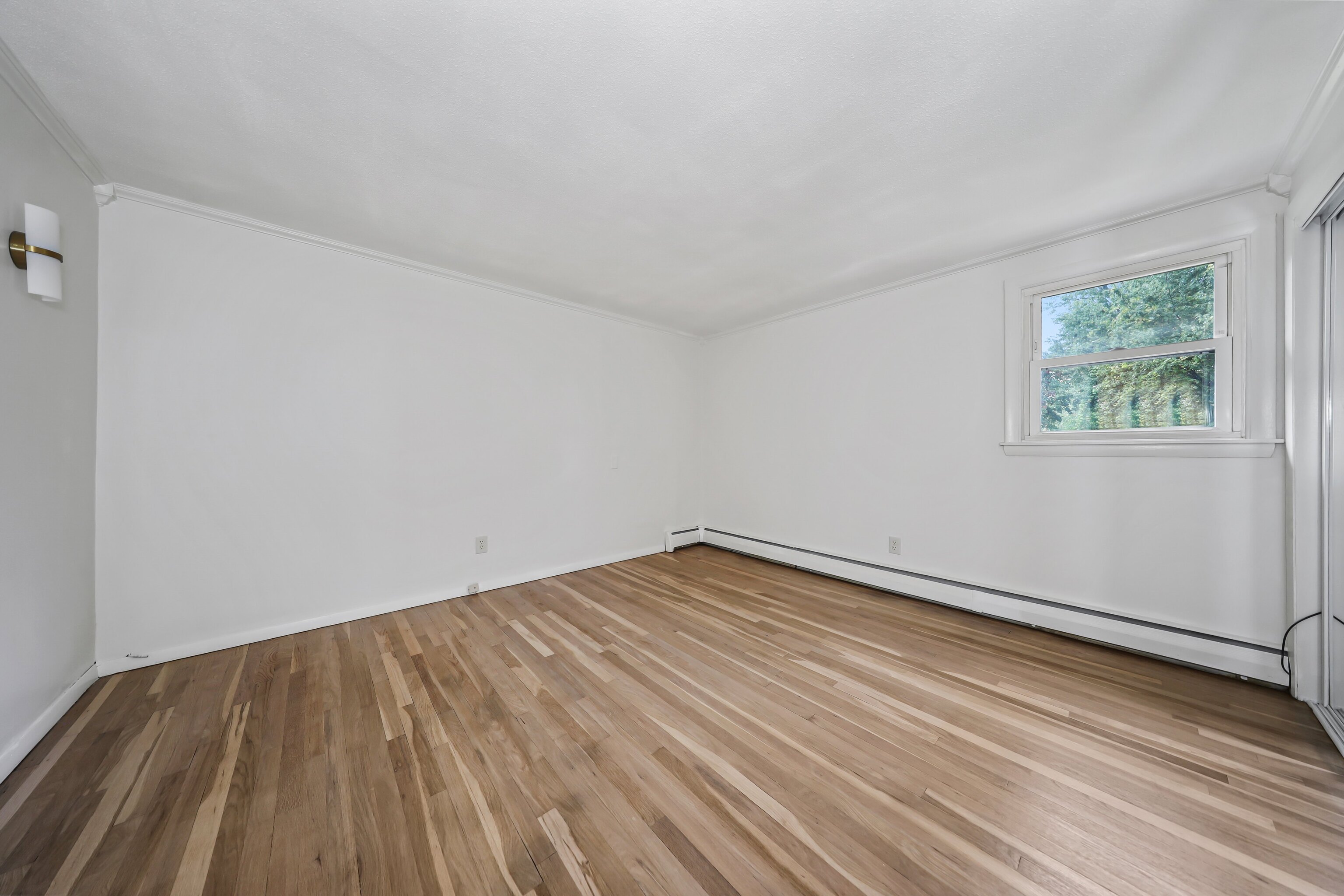 1114 Fienemann Road Farmington, CT 06032 - Photo 13 of 28 an empty room with wooden floor and windows