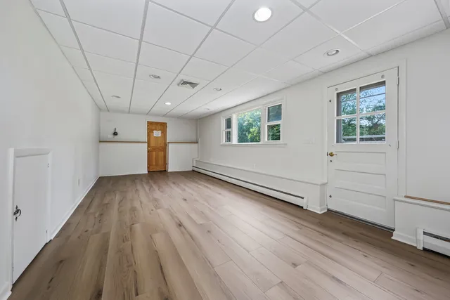 wooden floor in an empty room with a window