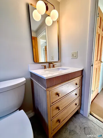 a bathroom with a sink a mirror and a toilet