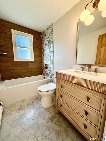 a bathroom with a sink a toilet and a bathtub