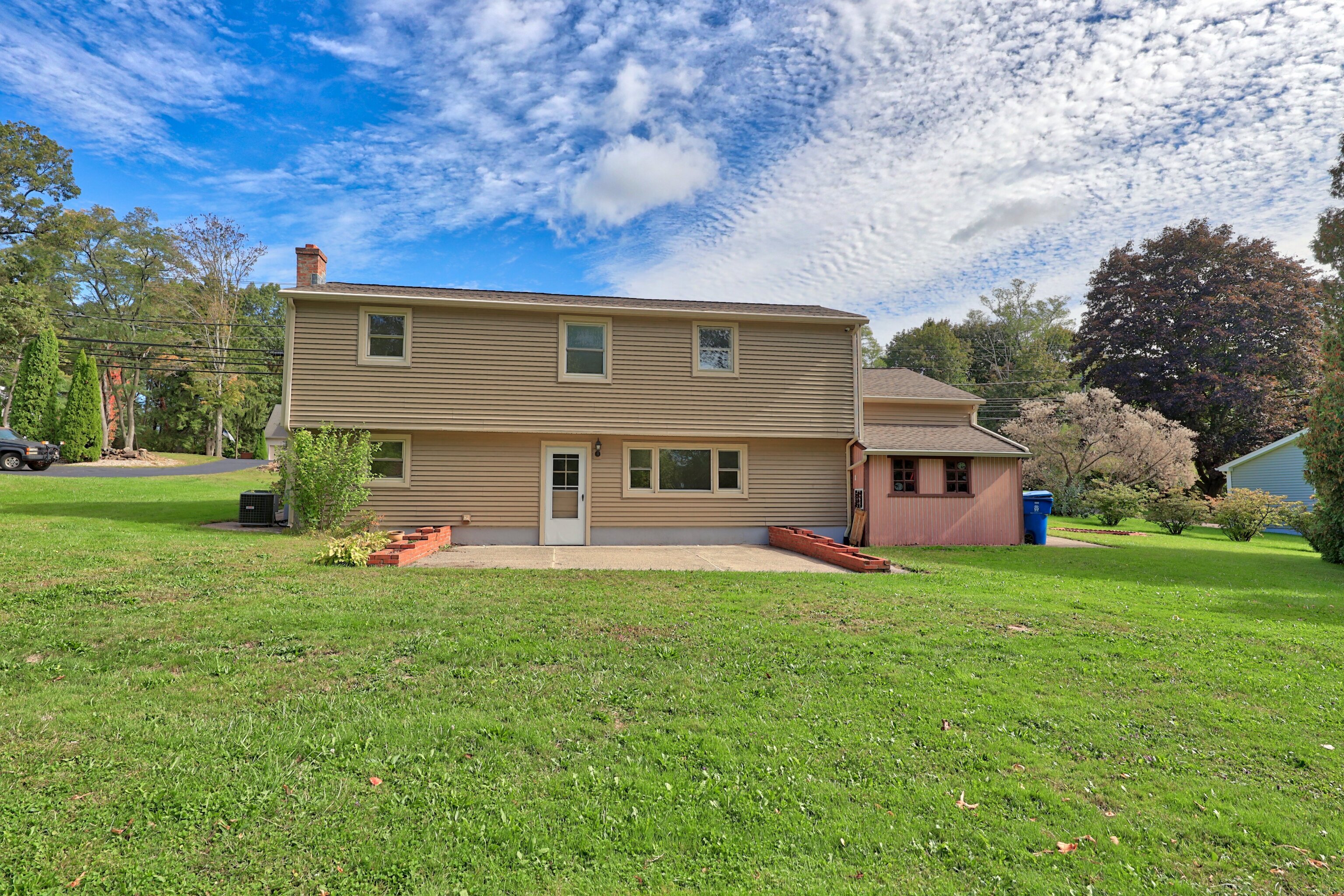 1114 Fienemann Road Farmington, CT 06032 - Photo 25 of 28 a view of a house with a big yard and large trees