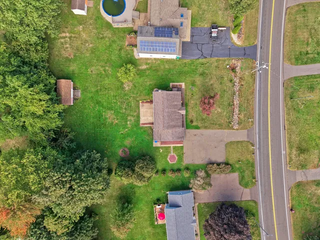 an aerial view of a house with outdoor space and street view