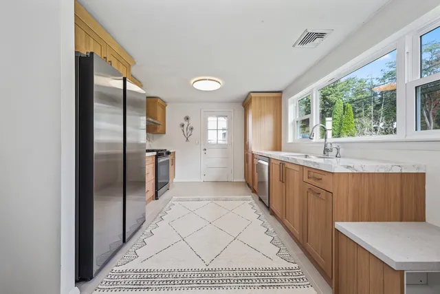 a large bathroom with a large mirror vanity and a shower