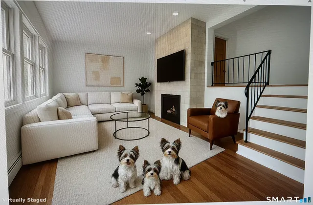 a living room with furniture fireplace and a flat screen tv