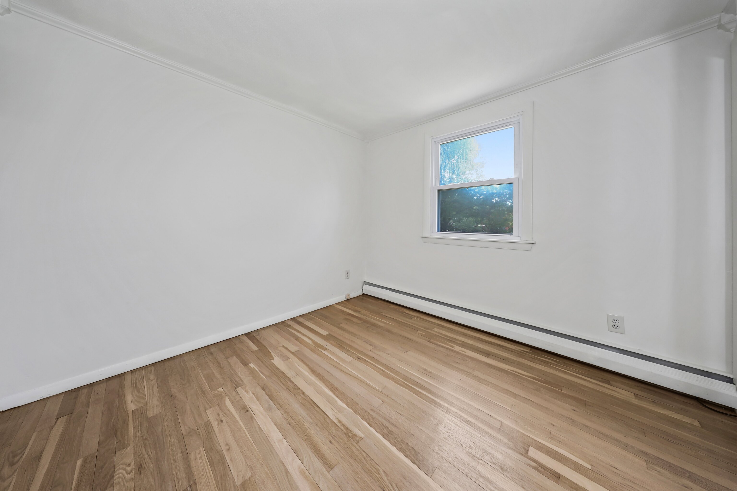 1114 Fienemann Road Farmington, CT 06032 - Photo 10 of 28 a view of an empty room with wooden floor and a window