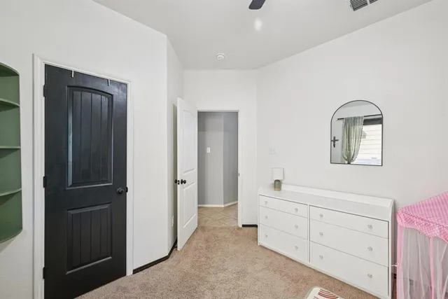 a view of a dresser and mirror in a room