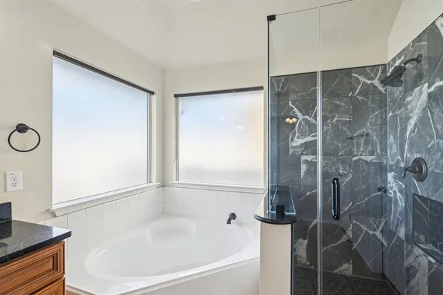 a bathroom with a bathtub and a shower