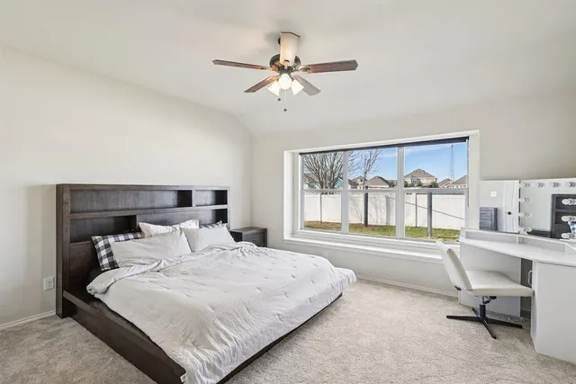 a bedroom with a large bed and a window