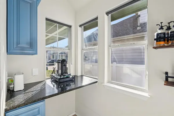 a kitchen with granite countertop a sink and a window
