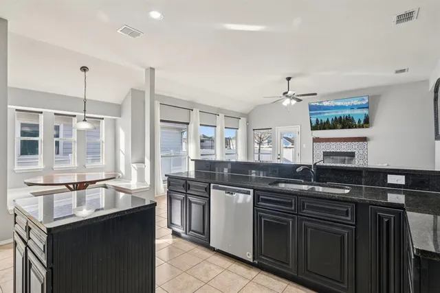 a kitchen with stainless steel appliances granite countertop a sink and stove