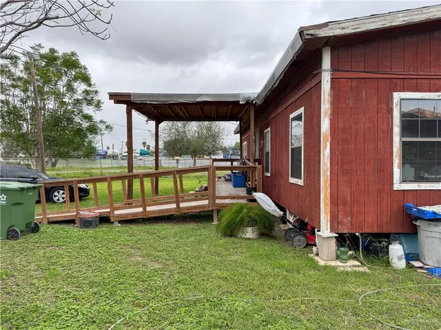 a view of a house with backyard and sitting area