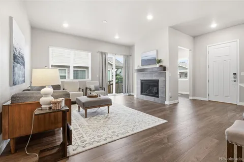 a living room with furniture fireplace and window