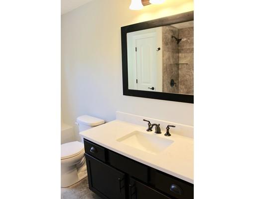 23 Manhattan Drive Burlington, MA 01803 - Photo 27 of 30 a bathroom with a sink a vanity and a mirror