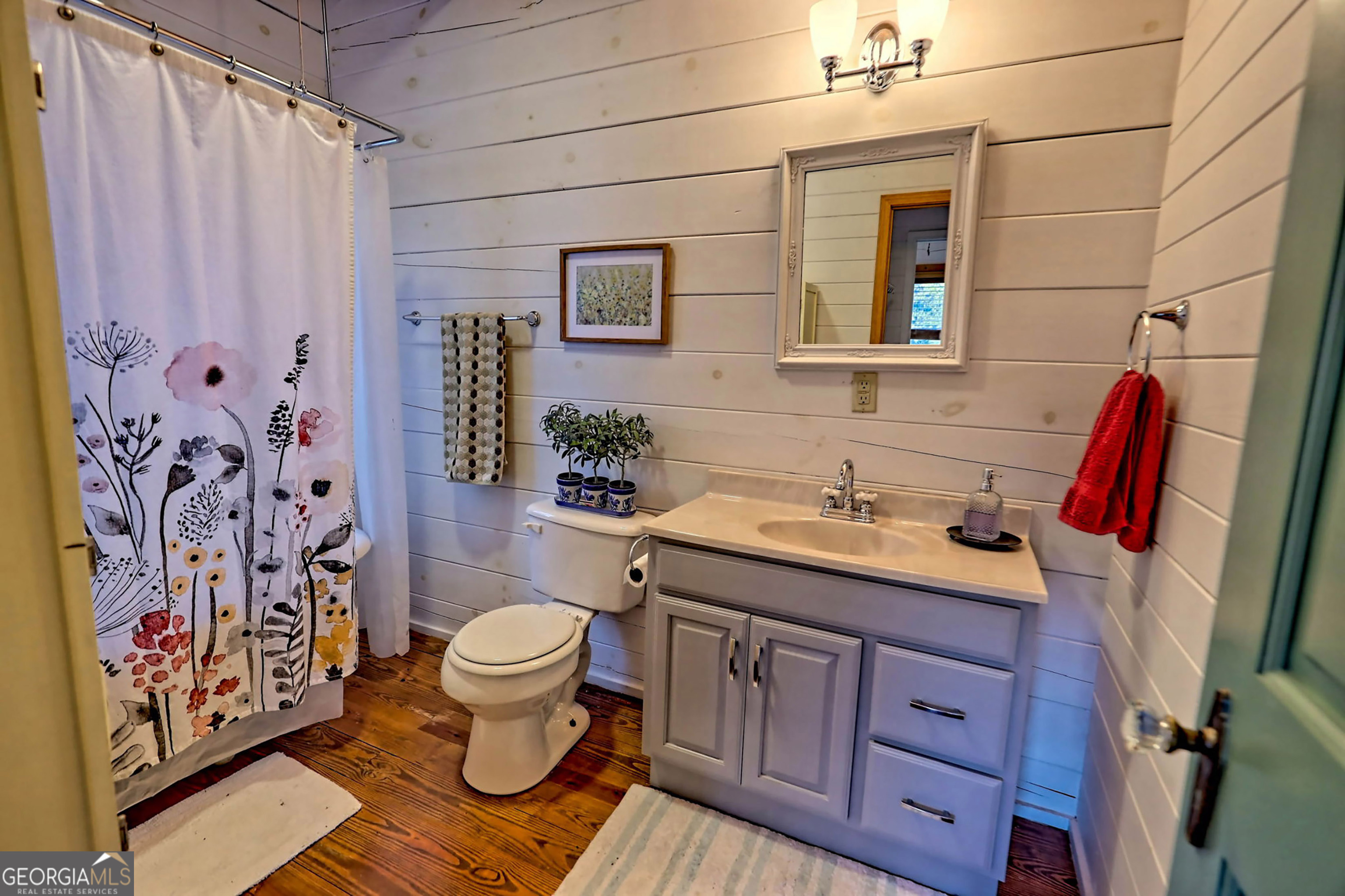 9406 Bridge Creek Road Tiger, GA 30576 - Photo 154 of 197 a bathroom with a granite countertop toilet sink and mirror