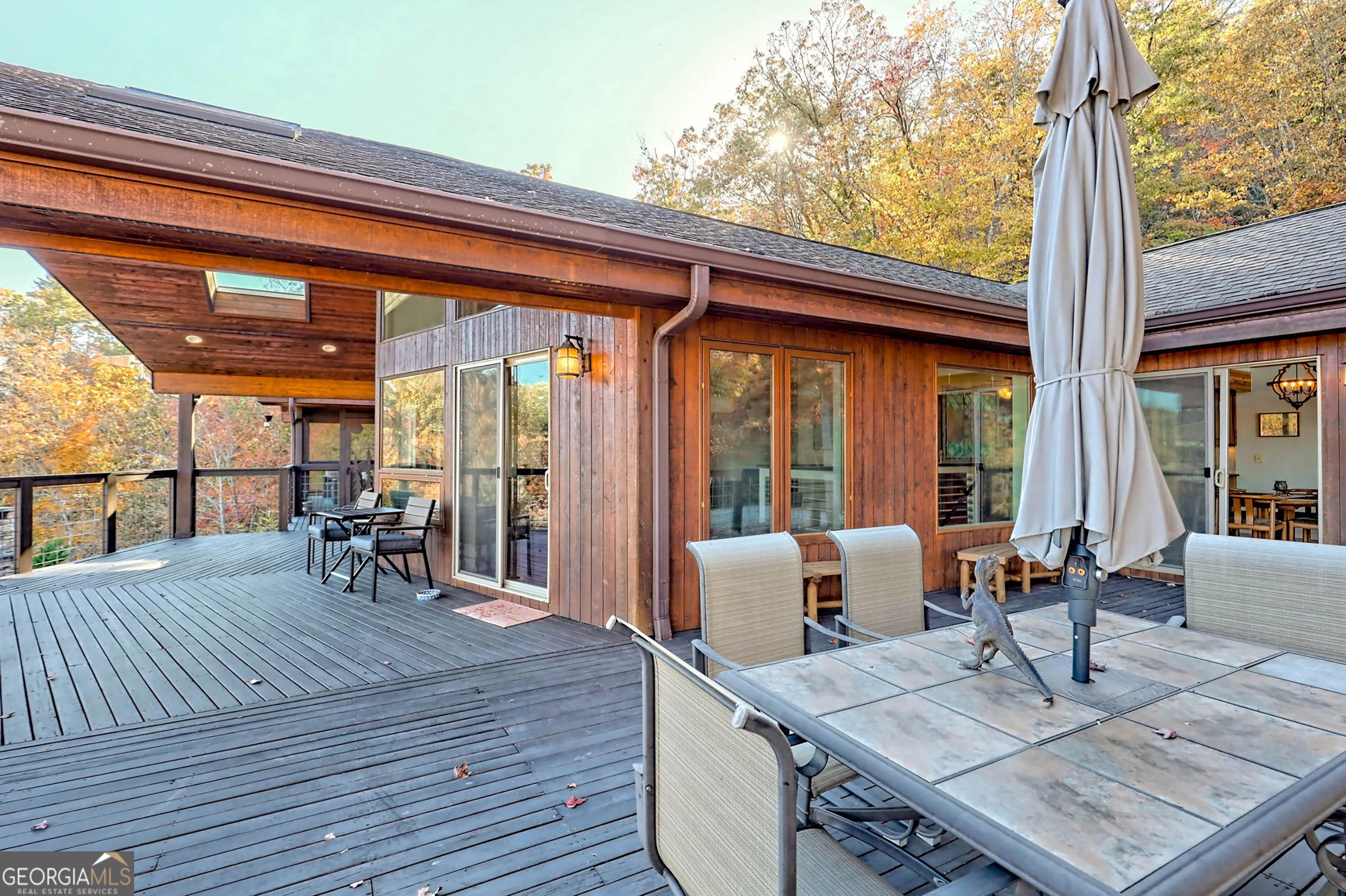 9406 Bridge Creek Road Tiger, GA 30576 - Photo 26 of 197 a view of a patio with table and chairs and wooden floor