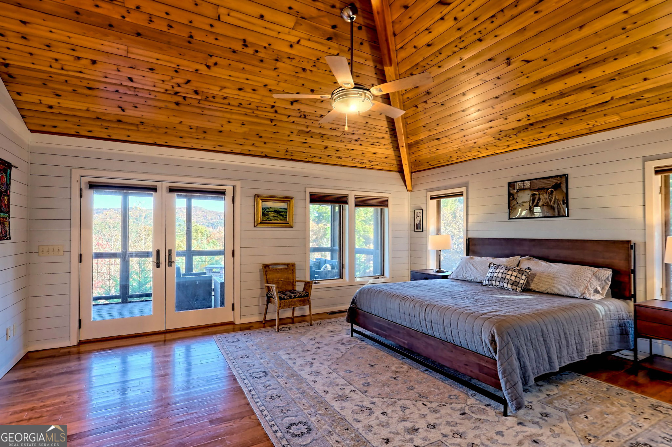 9406 Bridge Creek Road Tiger, GA 30576 - Photo 35 of 197 a bedroom with a large bed and a large window with wooden floor
