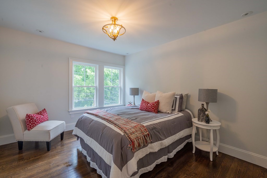 26 Locust Avenue Lexington, MA 02421 - Photo 24 of 42 a bedroom with a bed and a chandelier