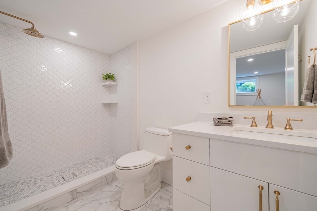 26 Locust Avenue Lexington, MA 02421 - Photo 34 of 42 a bathroom with a toilet a sink a mirror and vanity