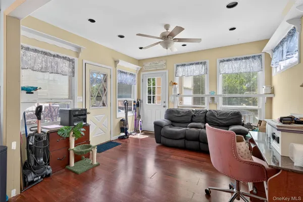 a living room with furniture window and wooden floor