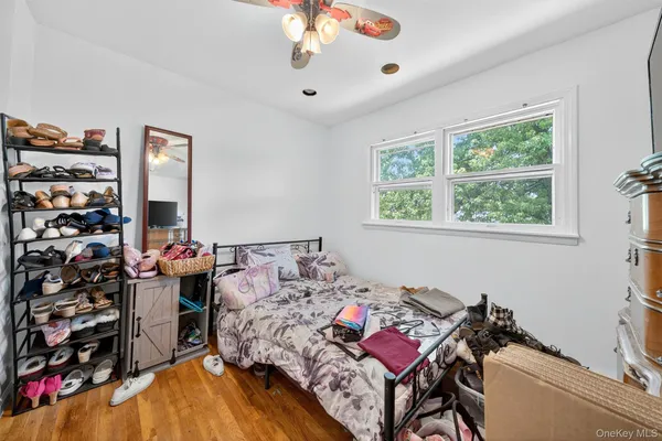 a bedroom with bed and a window