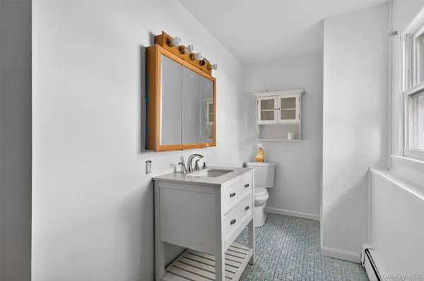 a bathroom with a mirror and a sink
