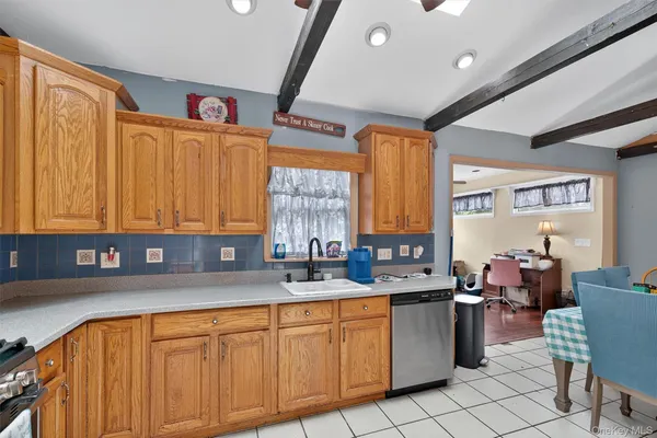 a kitchen with stainless steel appliances sink cabinets and window