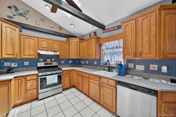 a kitchen with stainless steel appliances granite countertop a sink and cabinets