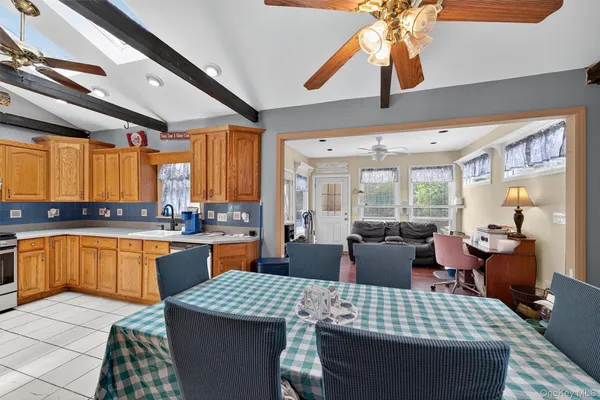 a large kitchen with a table and chairs