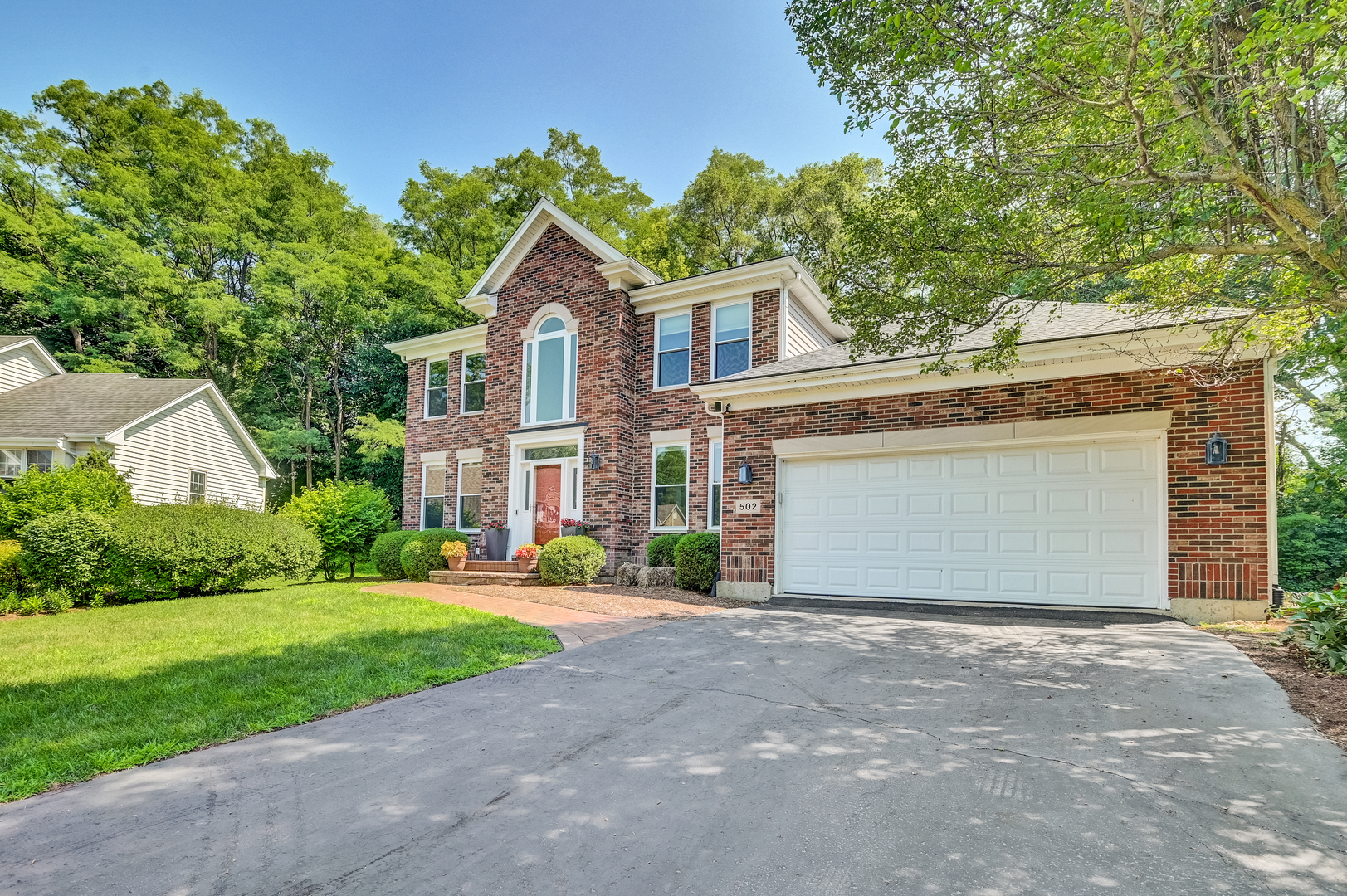 a front view of house with yard and green space