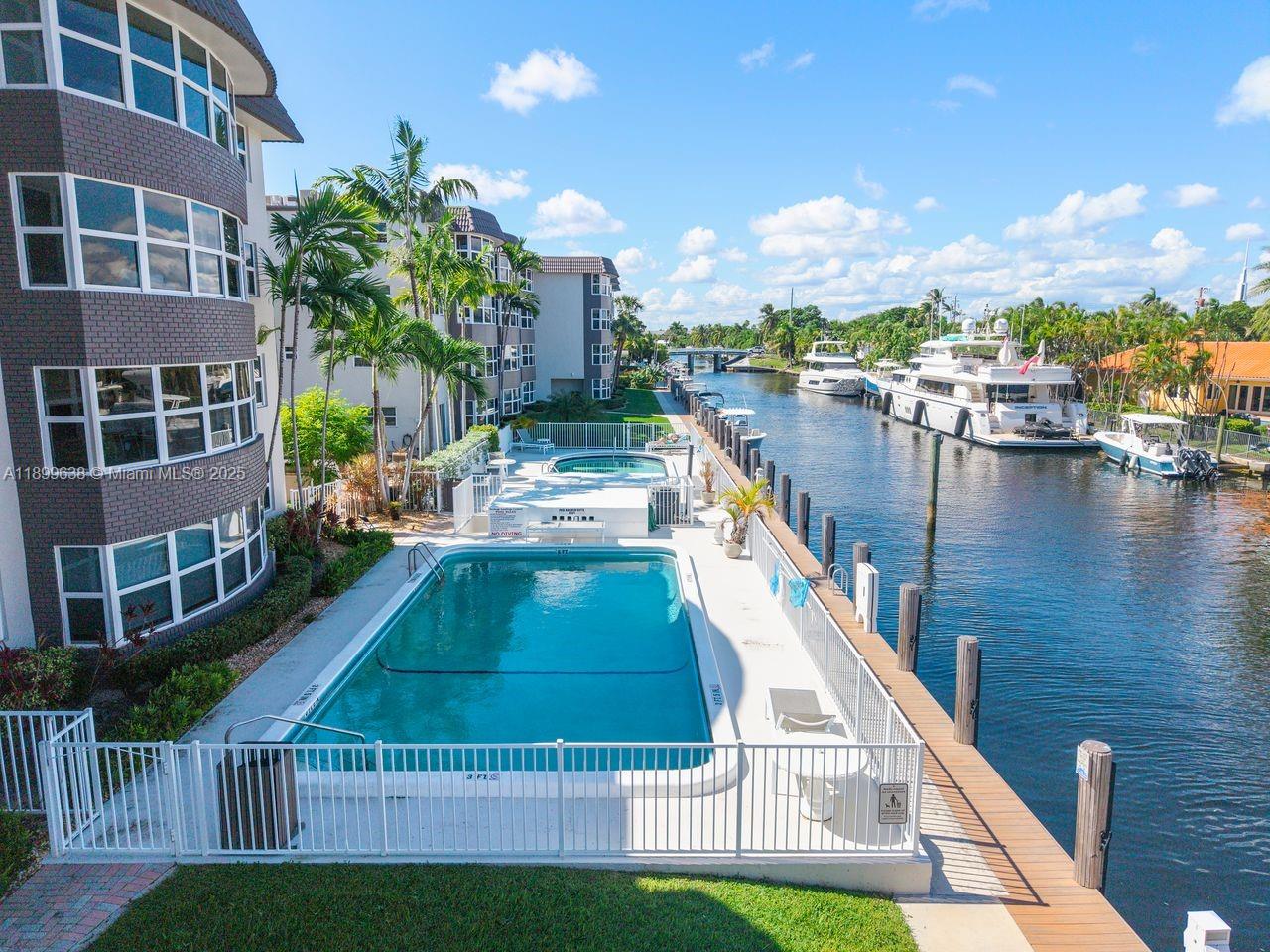 3111 Northeast 51st Street, Unit 202C Fort Lauderdale, FL 33308 - Photo 11 of 46 a house view with a swimming pool and outdoor space