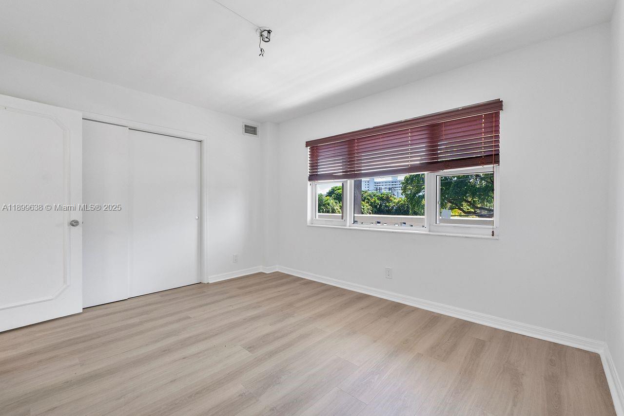 3111 Northeast 51st Street, Unit 202C Fort Lauderdale, FL 33308 - Photo 13 of 46 a view of an empty room with a window
