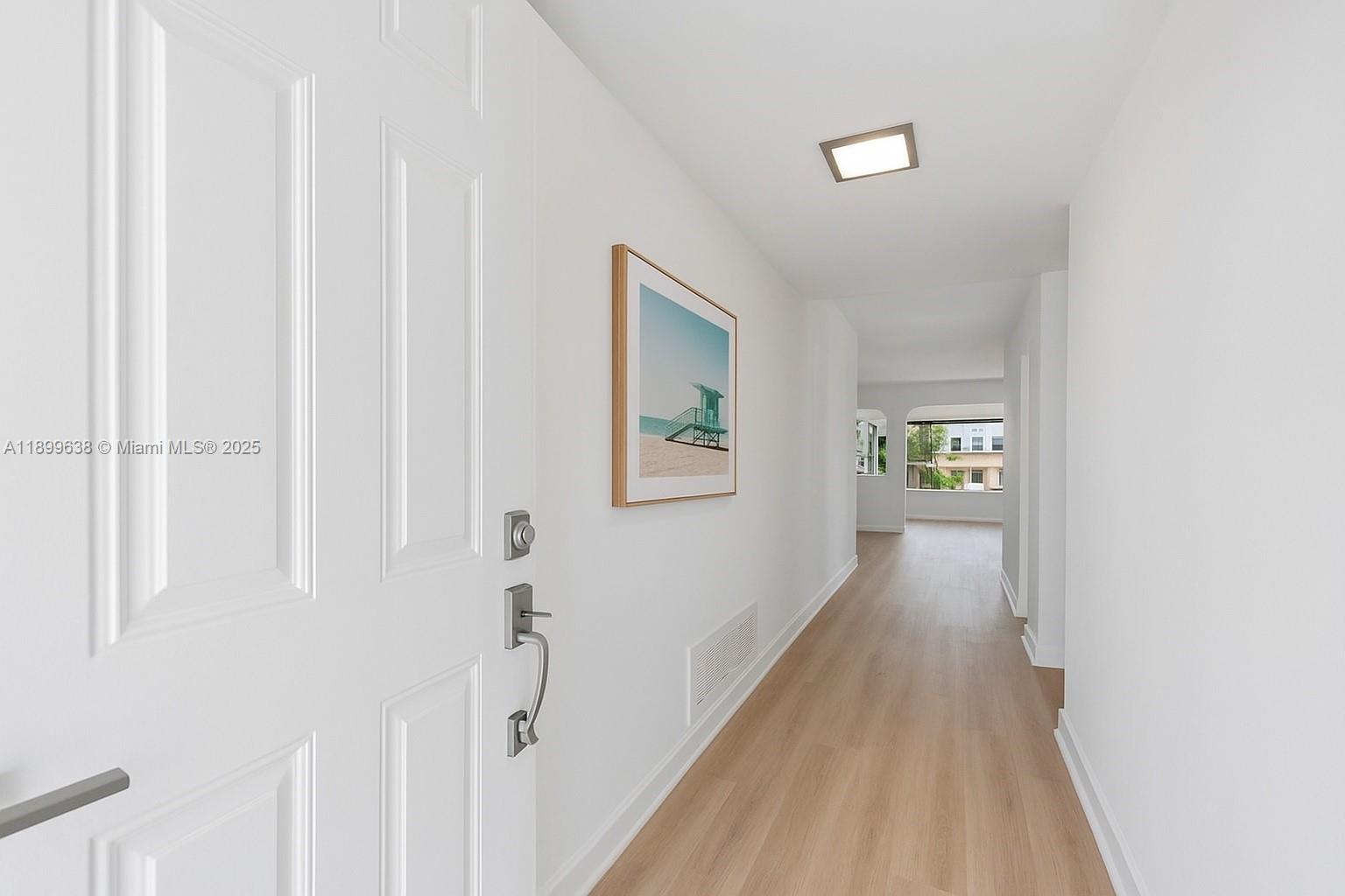 3111 Northeast 51st Street, Unit 202C Fort Lauderdale, FL 33308 - Photo 2 of 46 a view of a hallway with wooden floor