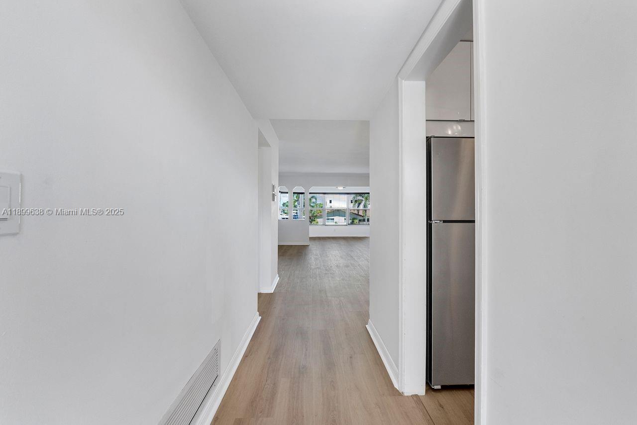 3111 Northeast 51st Street, Unit 202C Fort Lauderdale, FL 33308 - Photo 22 of 46 a view of a hallway with wooden floor
